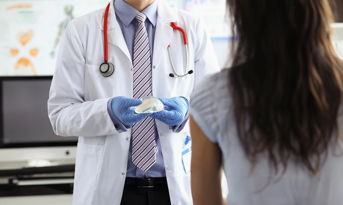 A patient choosing her breast implants for surgery in Singapore