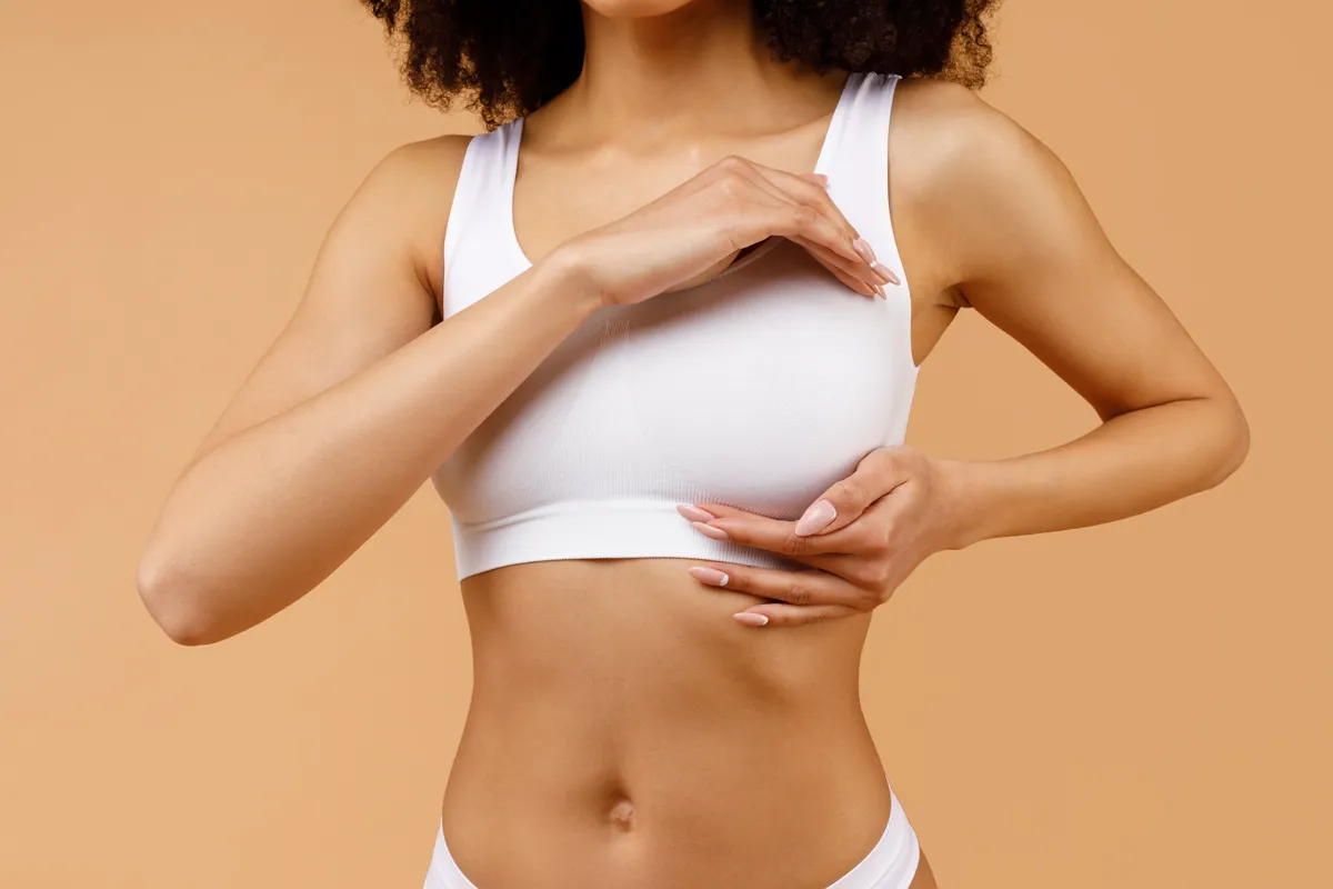 Woman checking breast implant placement